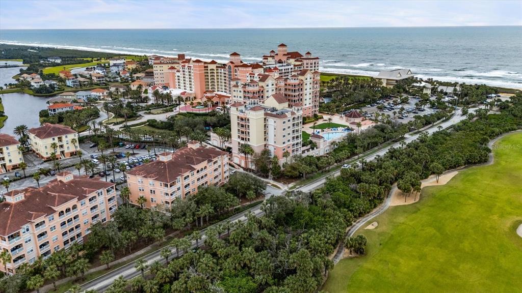 An aerial view of a large coastal resort complex with multiple buildings, parking, and landscaping — 5 OCEAN CREST WAY UNIT 1414, PALM COAST, FL