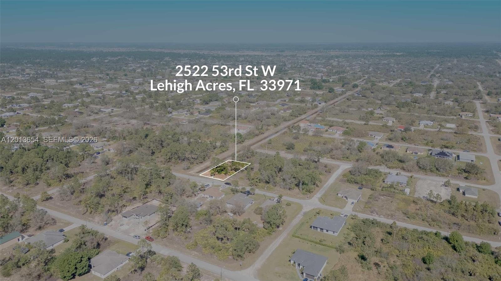 This aerial view shows a vacant, wooded residential lot in a suburban neighborhood — 2522 W 53RD ST, Lehigh Acres FL 33971, LEHIGH ACRES, FL