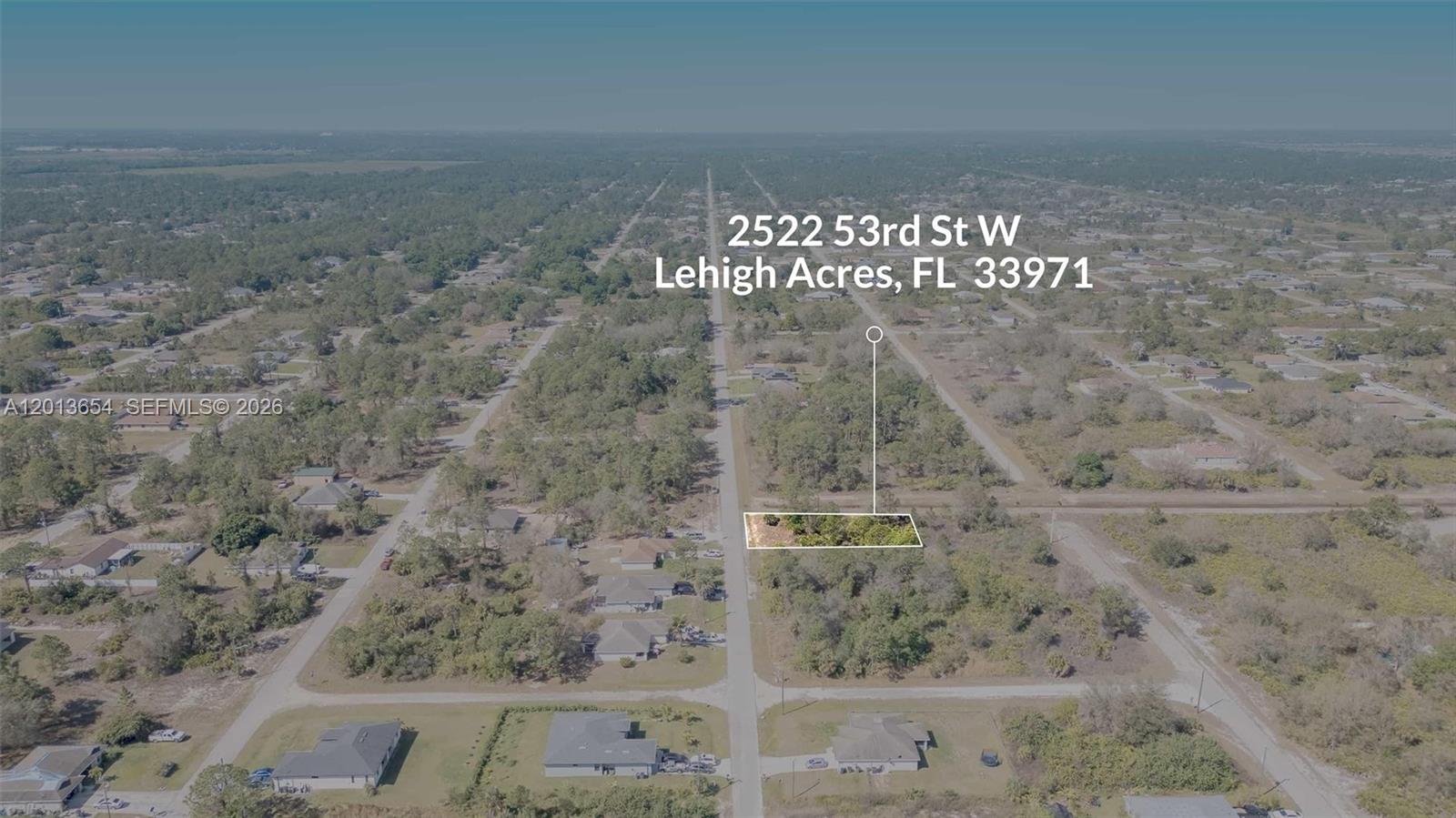 An aerial view shows a rectangular, undeveloped residential lot surrounded by trees and houses — 2522 W 53RD ST, Lehigh Acres FL 33971, LEHIGH ACRES, FL