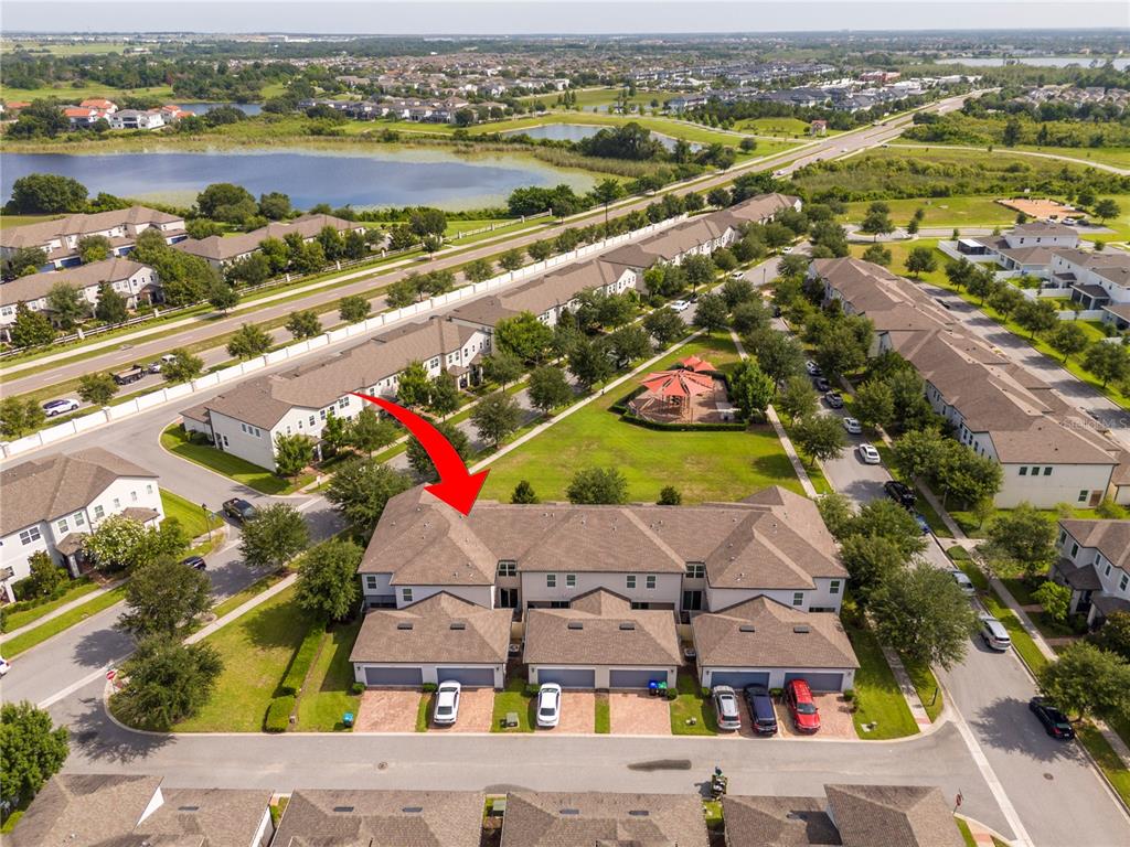 An aerial view shows a multi-unit townhouse building with a brown shingled roof — 14031 PICARD ALLEY, WINTER GARDEN, FL