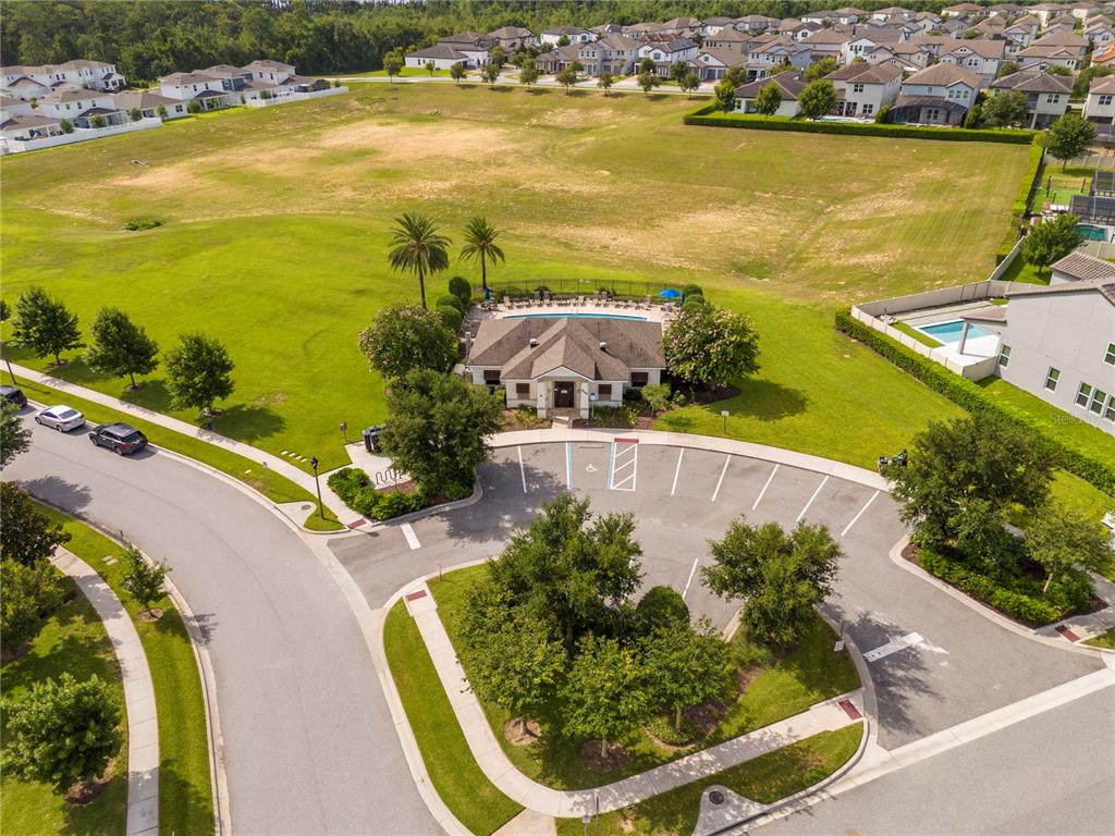 An aerial view shows a community clubhouse with a pool, parking lot, and surrounding homes — 14031 PICARD ALLEY, WINTER GARDEN, FL