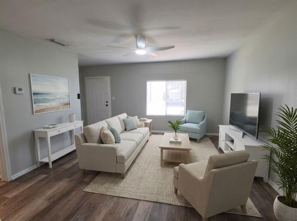 A living room features a light-colored sofa, two armchairs, a coffee table, and wood flooring — 506 N MACDILL AVENUE, TAMPA, FL