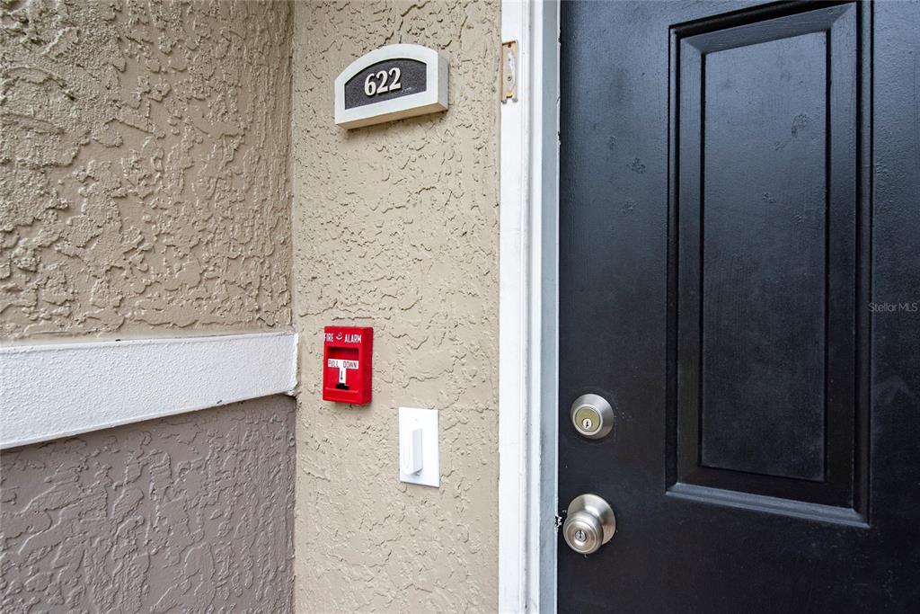 A black front door with a fire alarm pull station and unit number 622 — 6548 SWISSCO DRIVE UNIT 622, ORLANDO, FL