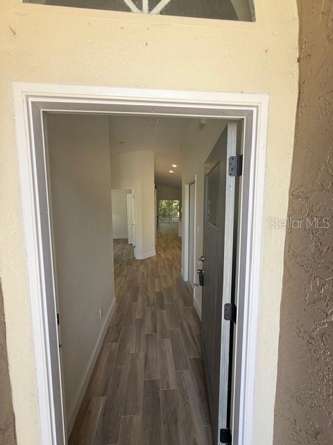 A view through an open front door into a hallway with wood-look tile flooring — 108 SUNDANCE COURT, WINTER SPRINGS, FL
