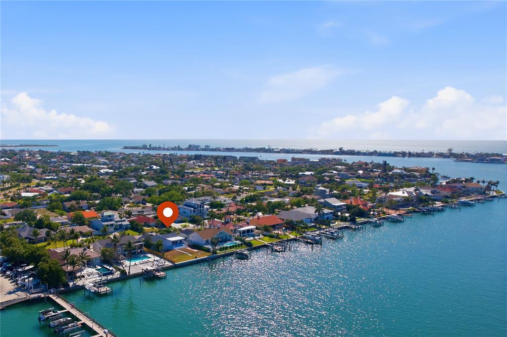 An aerial view shows a waterfront residential neighborhood with a red pin marking a property — 155 1ST STREET W, TIERRA VERDE, FL