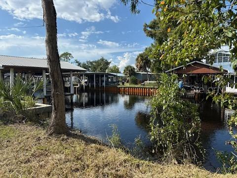 A view of a canal with boat docks and houses under a blue sky — 71 SE 893 AVENUE, OLD TOWN, FL