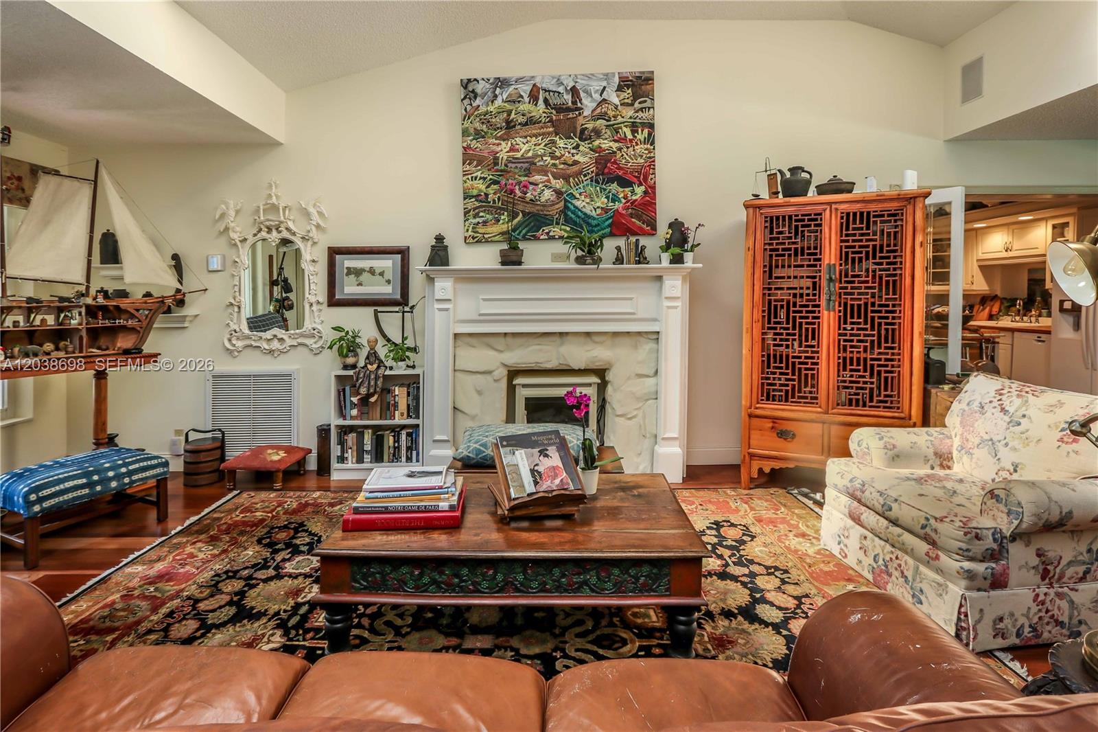 A living room features a fireplace, a large wooden cabinet, and a patterned area rug — 1251 Buchanan St, Hollywood FL 33019, HOLLYWOOD, FL