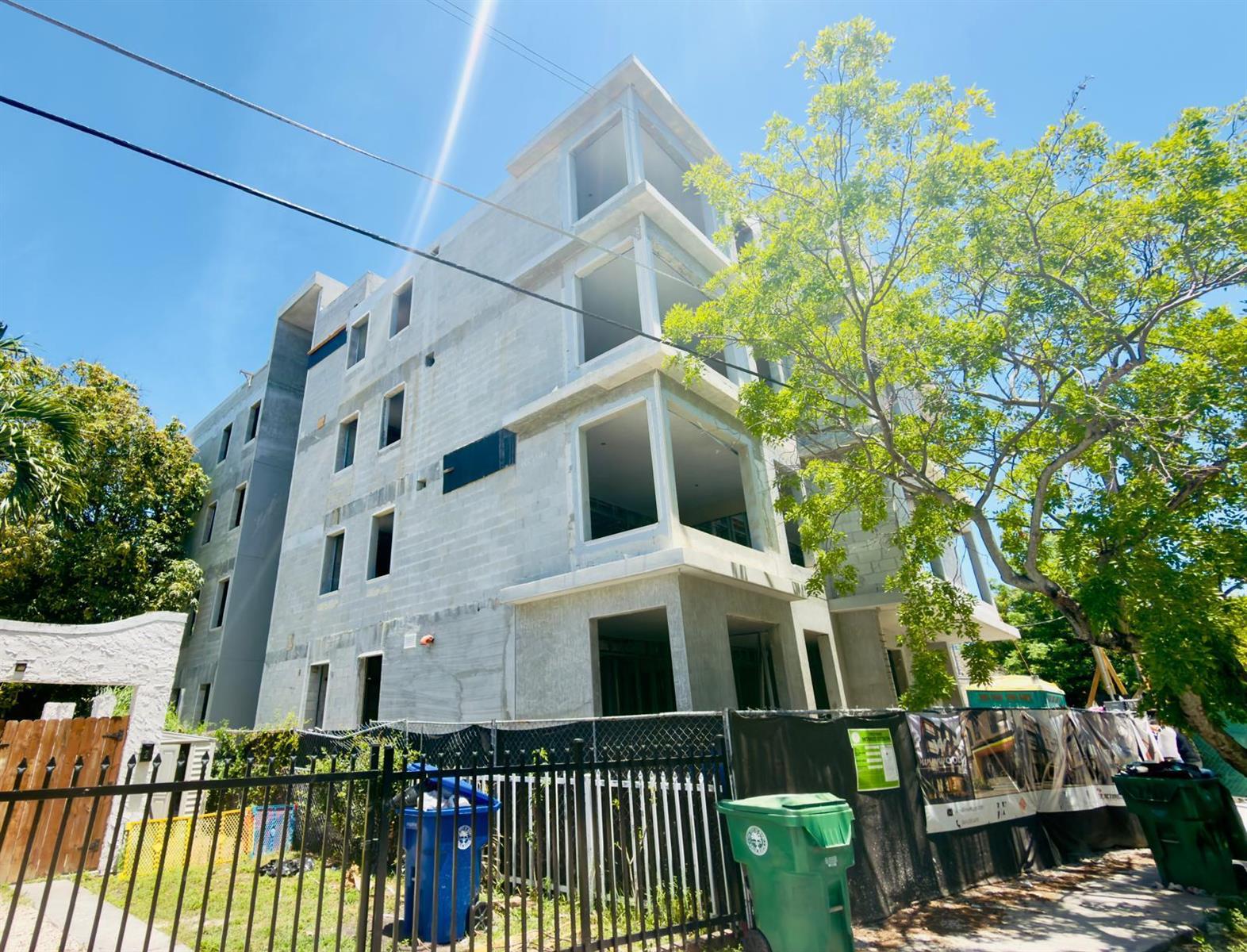 A multi-story concrete building under construction stands behind a black metal fence — 259 NW 33rd Street # 2, Miami FL 33127, MIAMI, FL