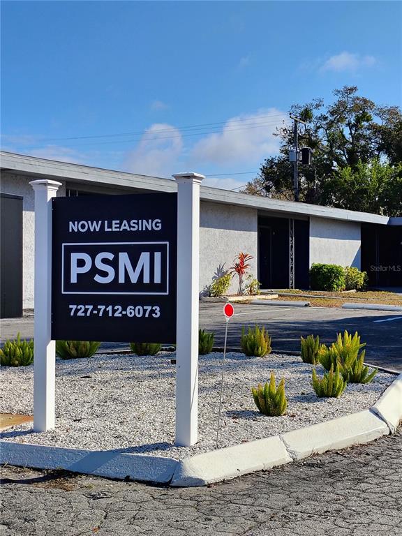 A leasing sign for PSMI stands in front of a single-story commercial building — 407 S JUPITER AVENUE UNIT 7, CLEARWATER, FL