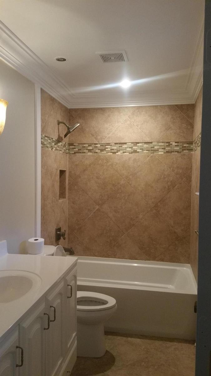 A bathroom features a white vanity, a toilet, and a bathtub with tiled walls — 22447 SW 56th Avenue, Boca Raton FL 33433, BOCA RATON, FL