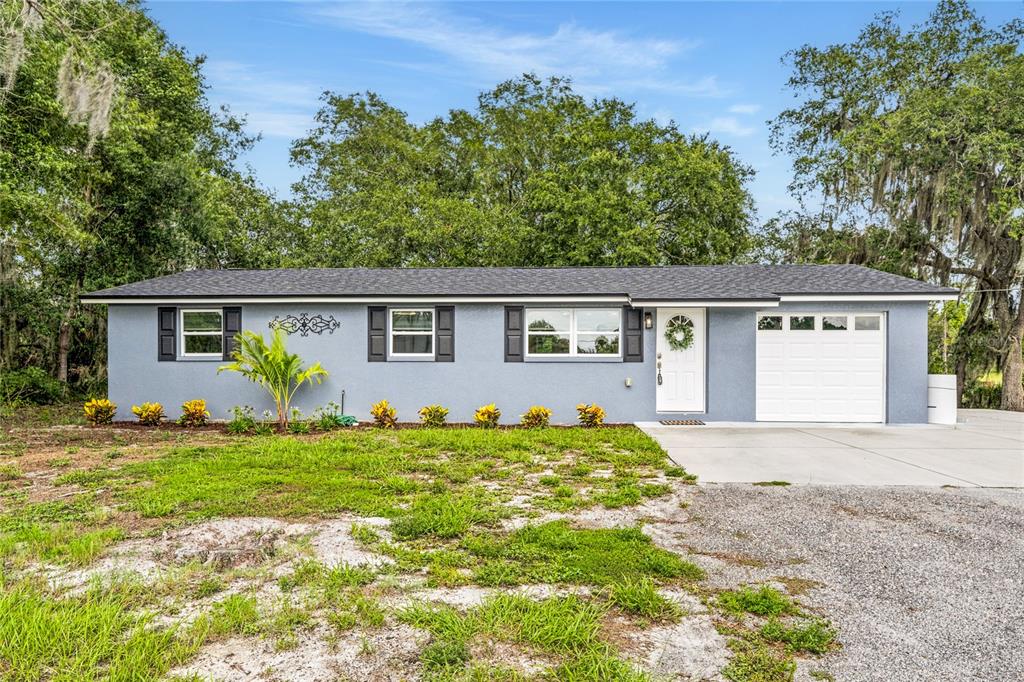 This is a floor plan for a three-bedroom, two-bathroom house with an attached garage — 749 N SR 415, OSTEEN, FL