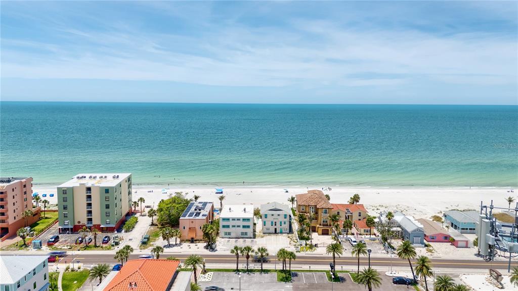 An aerial view of a beach with several buildings and a road in the foreground — 19310 GULF BOULEVARD, INDIAN SHORES, FL