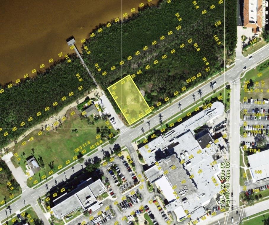 An aerial map view shows a rectangular vacant lot highlighted in yellow near a road — 806 E MARION AVENUE, PUNTA GORDA, FL
