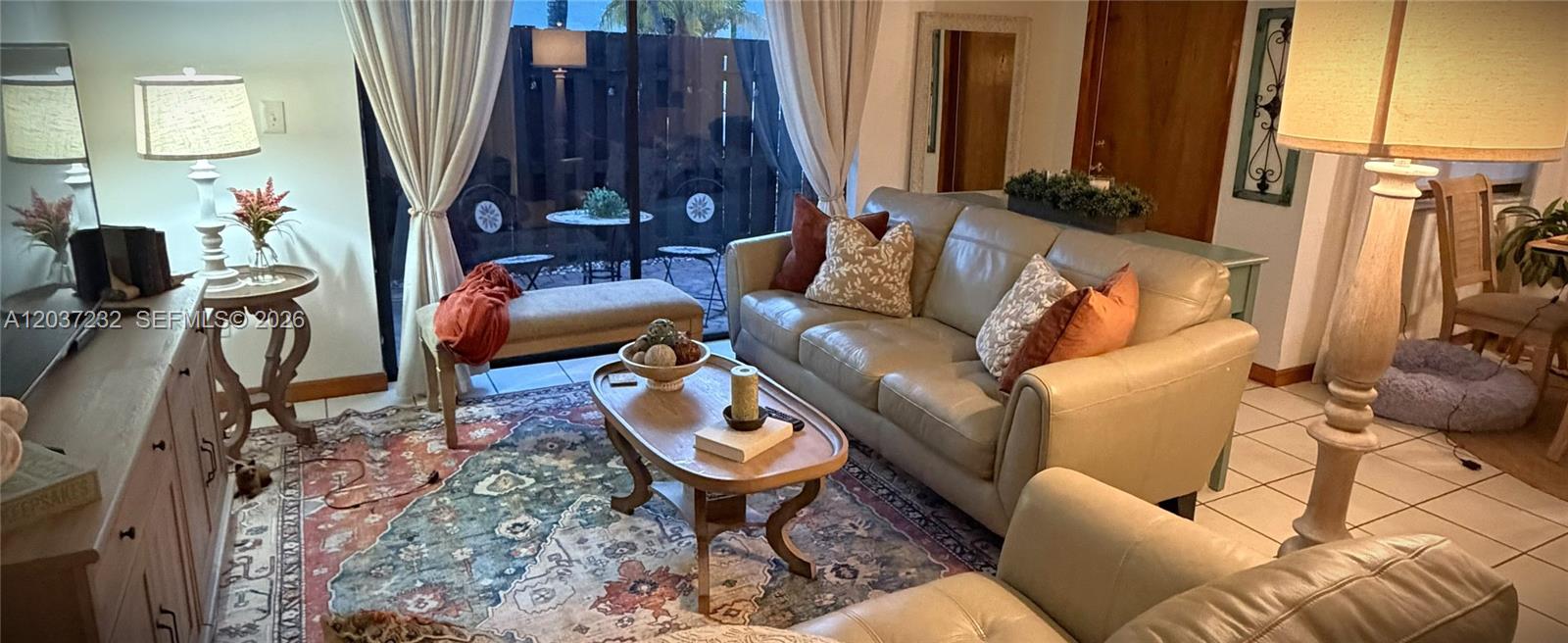 A living room features a leather sofa, patterned area rug, coffee table, and floor lamp — 10445 SW 154th Ct # 1, Miami FL 33196, MIAMI, FL