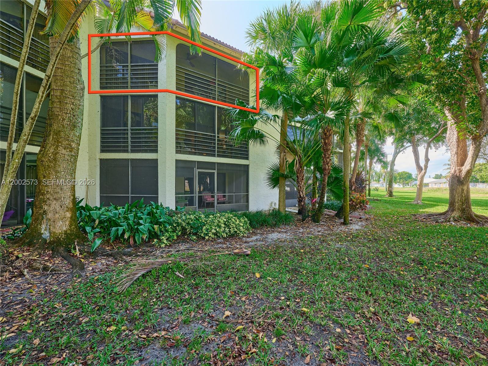 The exterior of a multi-story building features a screened-in balcony on the top floor — 10143 Mangrove Dr # 303, Boynton Beach FL 33437, BOYNTON BEACH, FL