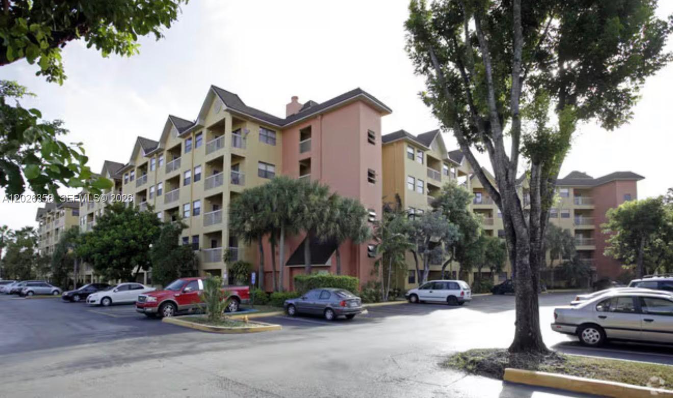 A multi-story apartment building with a parking lot in the foreground — 8290 Lake Dr # 143, Doral FL 33166, DORAL, FL