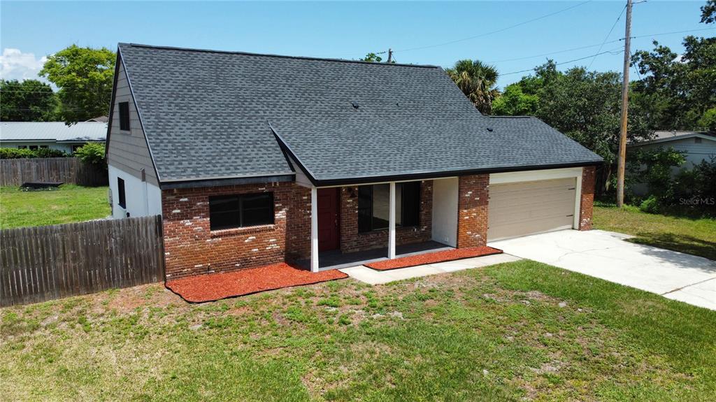 An exterior view of a two-story brick and siding house with a two-car garage — 1804 PONDEROSA LANE, TITUSVILLE, FL