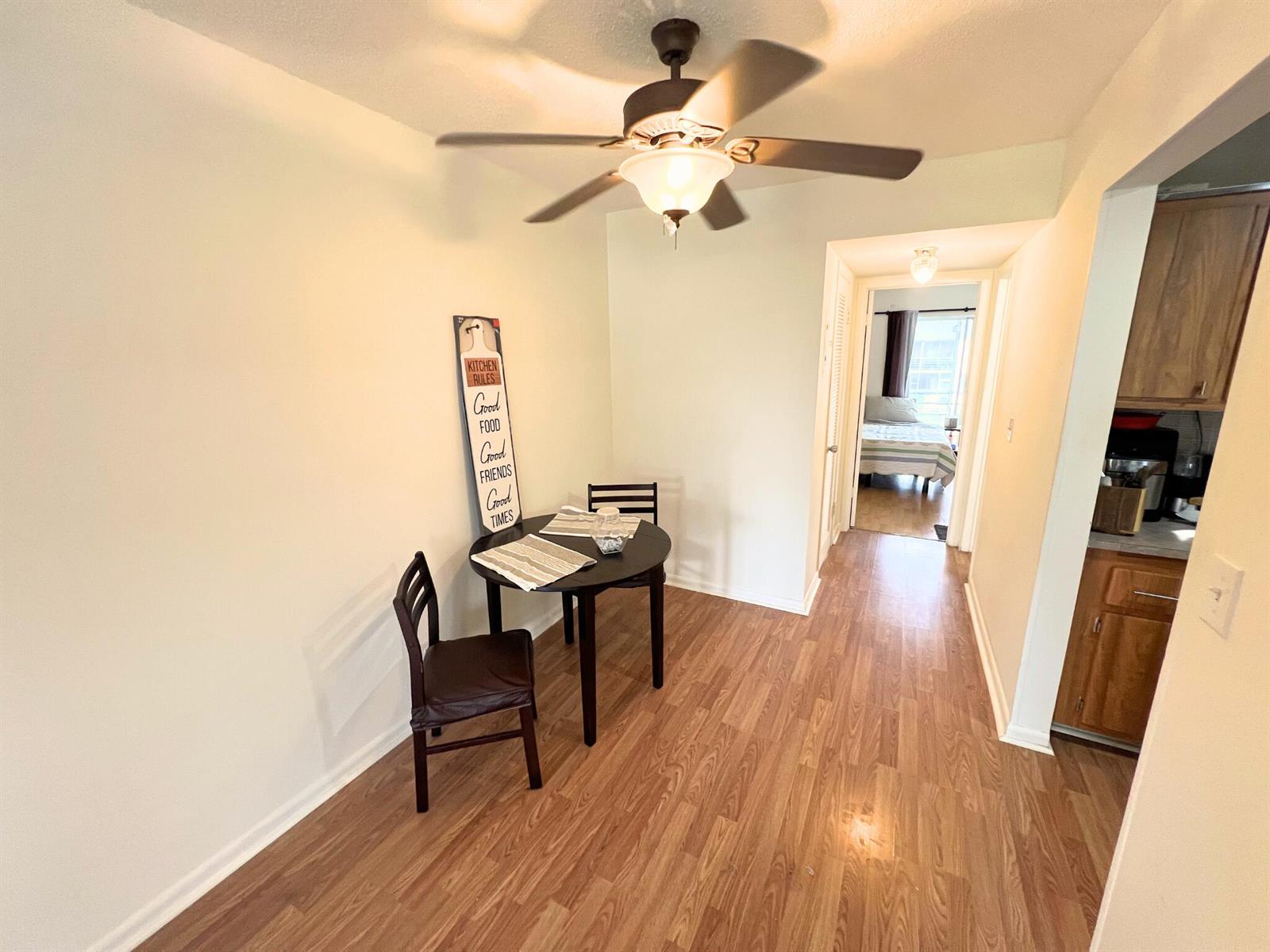 A small dining area features a round table, two chairs, and a ceiling fan — 124 E Andover E # 124, West Palm Beach FL 33417, WEST PALM BEACH, FL