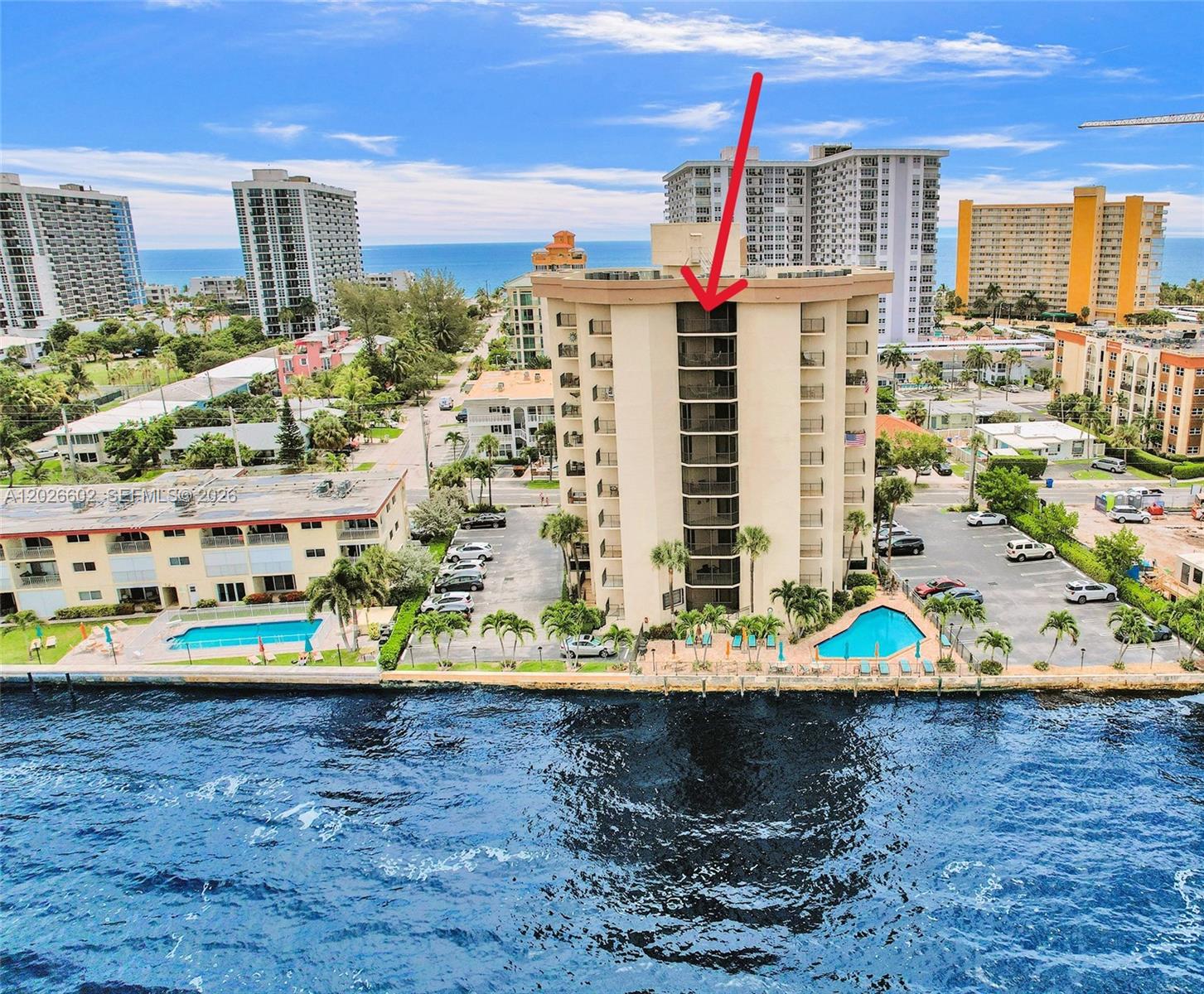 An aerial view shows a multi-story residential building with a red arrow pointing to balconies — 501 N Riverside Dr, Pompano Beach FL 33062, POMPANO BEACH, FL