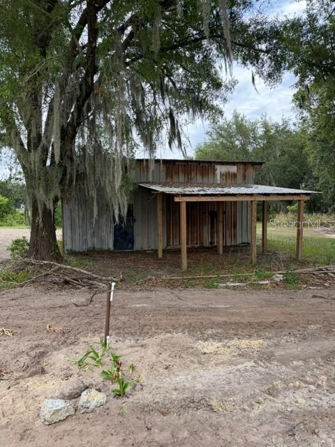 A kitchen with white cabinets, granite countertops, stainless steel appliances, and light wood-look flooring — 3036 THORNHILL ROAD, WINTER HAVEN, FL