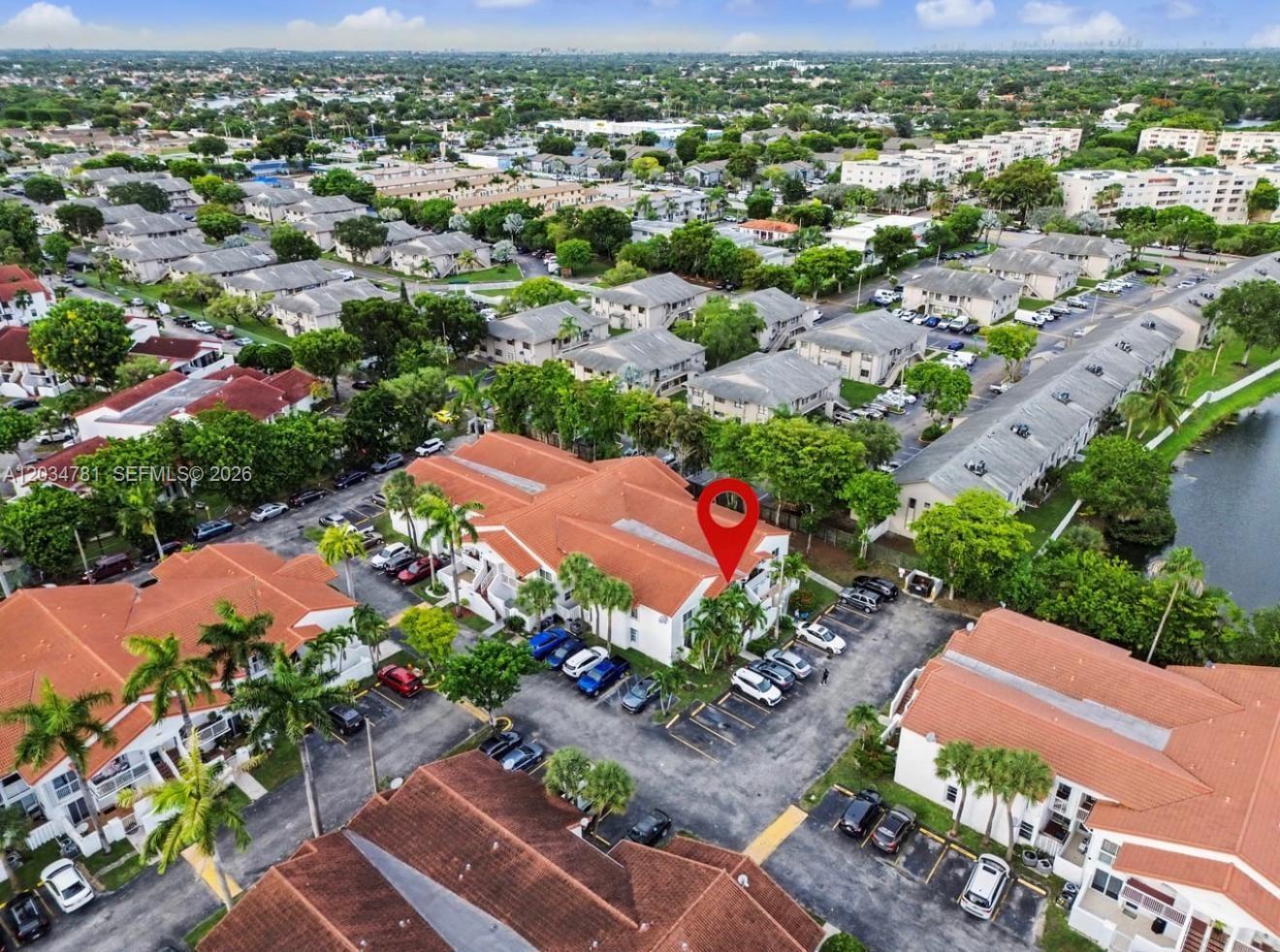 An aerial view shows a multi-story residential building with a red tile roof — 7611 SW 153rd Ct # 204, Miami FL 33193, MIAMI, FL