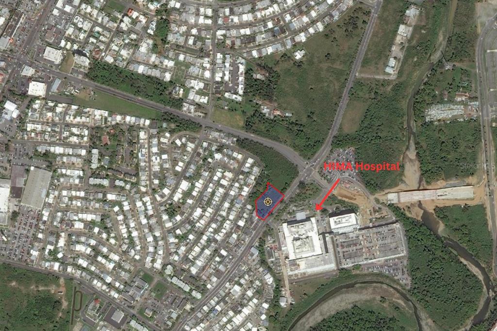 This is an aerial map showing a highlighted plot of land near a hospital — Avenida Luis Muñoz Marin BARRIO TURABO Lote 1, CAGUAS, PR