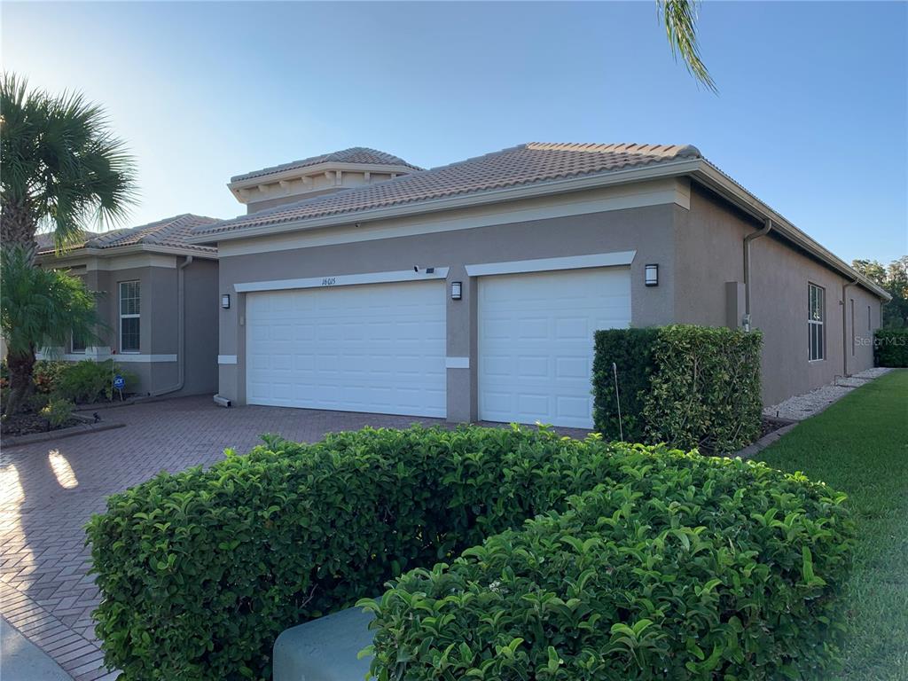 An aerial view of a single-story house with a tile roof and a brick driveway — 16015 CAPE CORAL DRIVE, WIMAUMA, FL