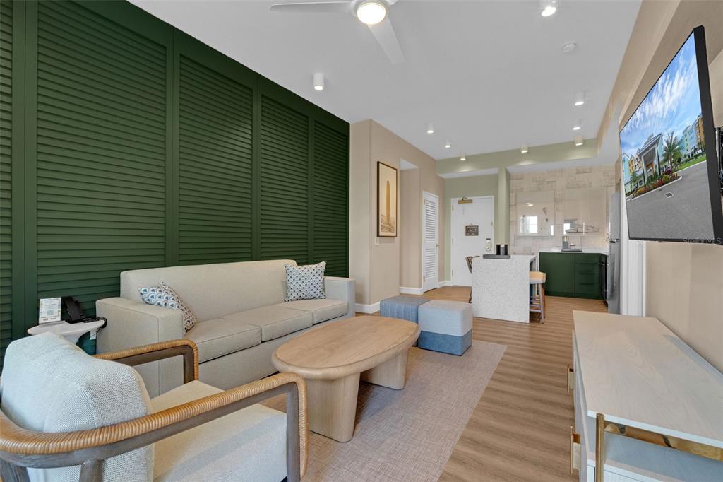 A living room features a green louvered accent wall, light-colored sofa, and wood coffee table — 3151 SUNSET WALK DRIVE UNIT 1108, KISSIMMEE, FL