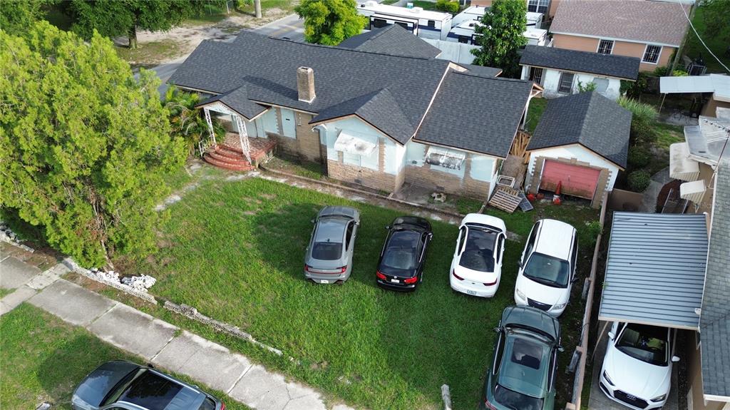 An aerial view of a single-story house with a large lawn and multiple parked cars — 2511 E 21ST AVENUE, TAMPA, FL