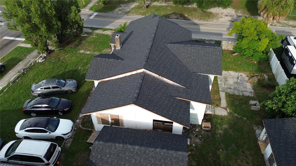 An aerial view of a house with a new dark shingled roof and parked cars — 2511 E 21ST AVENUE, TAMPA, FL