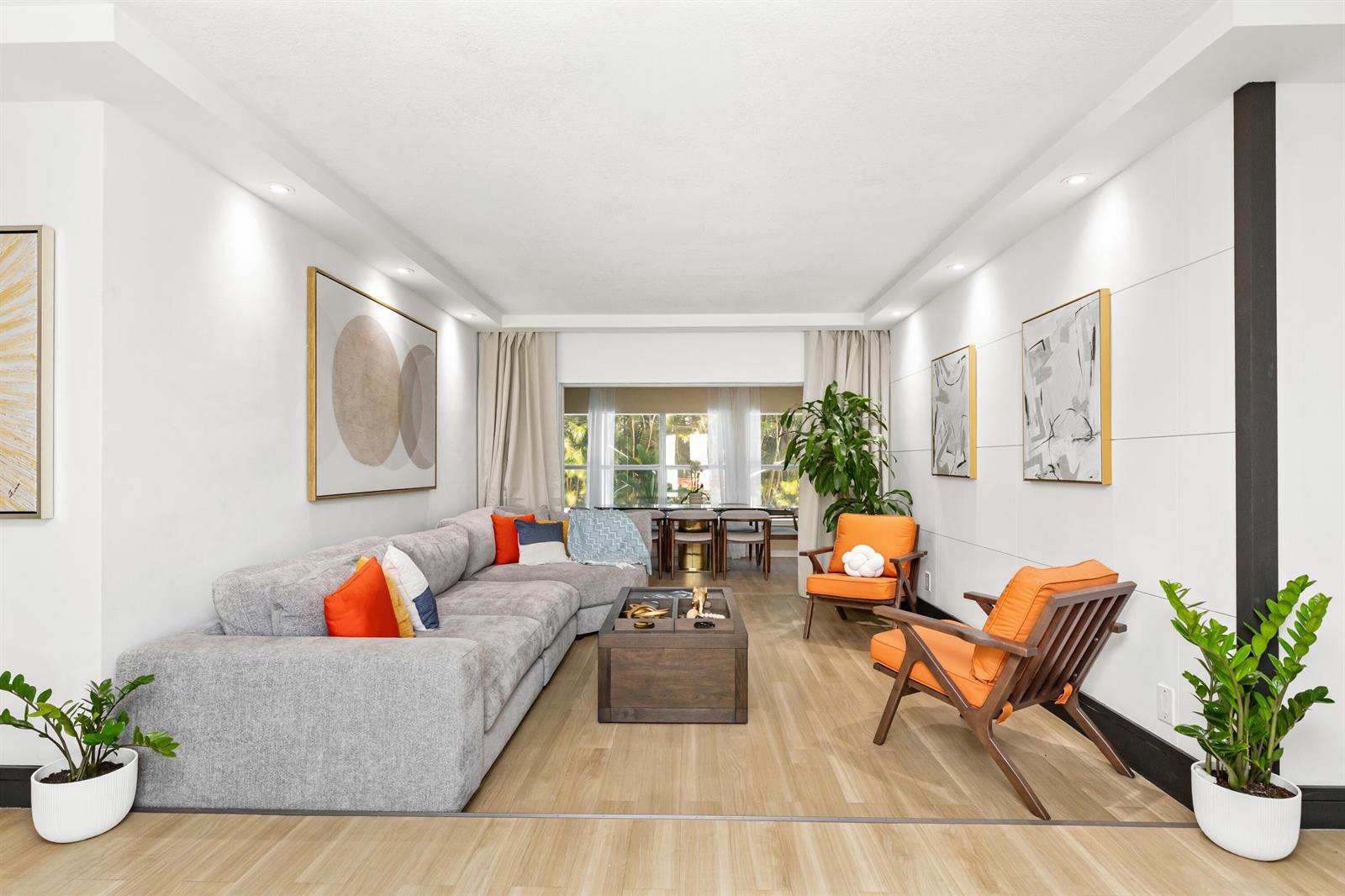 A living room features a grey sectional sofa, two orange armchairs, and light wood flooring — 1431 NW 70th Way, Plantation FL 33313, PLANTATION, FL