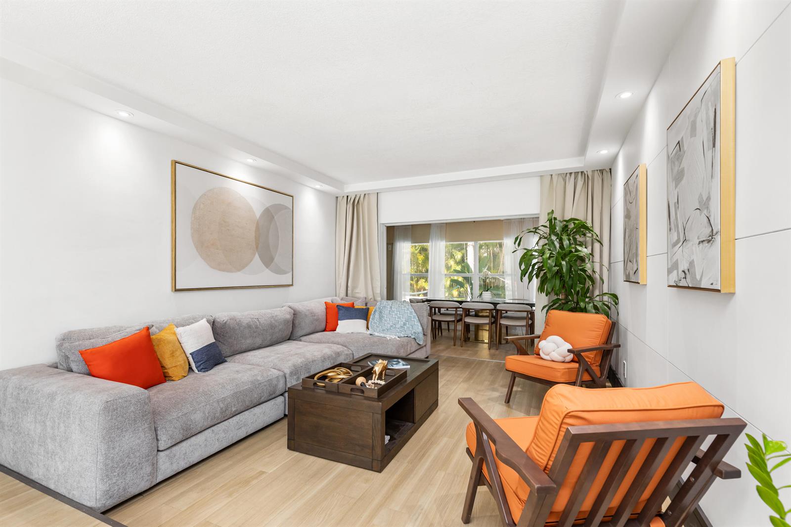 A living room features a grey sectional sofa, two orange armchairs, and a wooden coffee table — 1431 NW 70th Way, Plantation FL 33313, PLANTATION, FL
