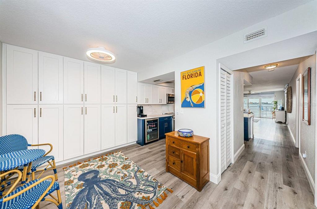 A room with white cabinetry, a small wet bar, and a patterned octopus area rug — 6105 BAHIA DEL MAR CIRCLE UNIT 287, ST PETERSBURG, FL