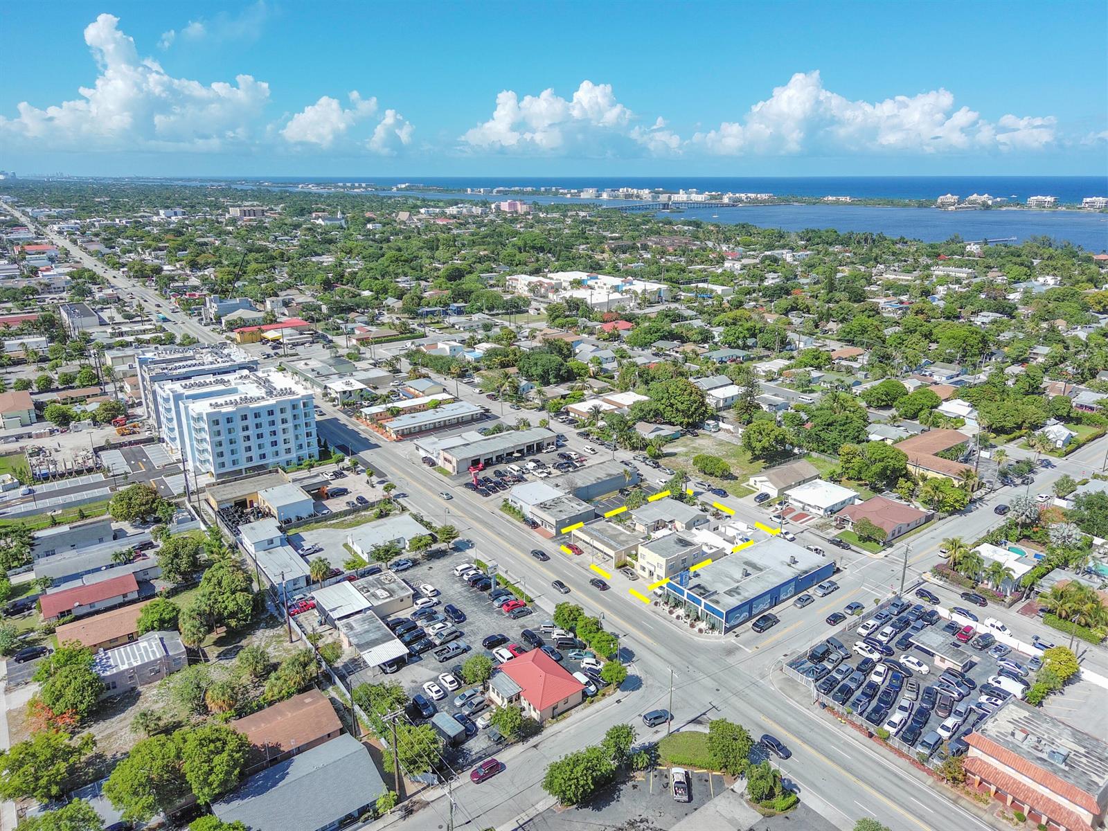 An aerial view shows a commercial building highlighted in yellow amidst a suburban neighborhood — 922 & 928 S Dixie Highway, FL 33462, FL