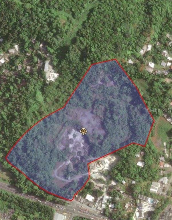 An aerial view shows a plot of land outlined in red, surrounded by dense vegetation — FELIPE LA VOZ RODRIGUEZ, GUAYNABO, PR