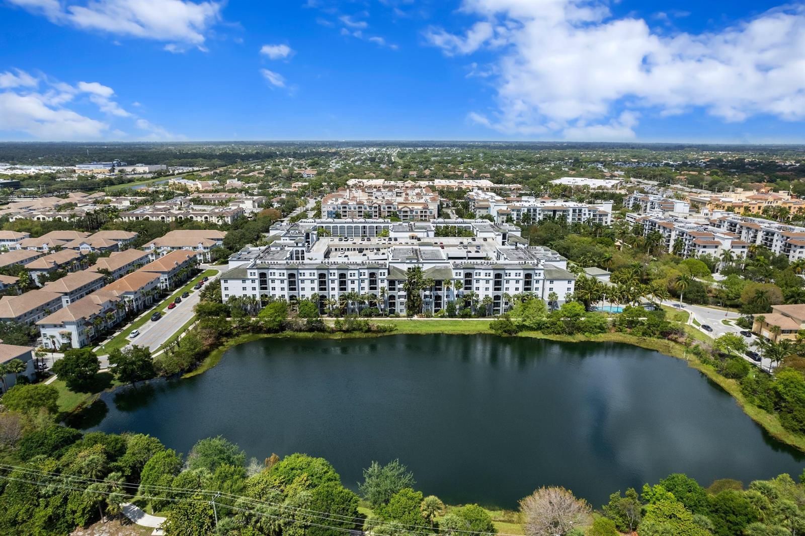 An aerial view shows a large apartment complex situated next to a lake — 1660 Renaissance Commons Boulevard # 2629, Boynton Beach FL 33426, BOYNTON BEACH, FL