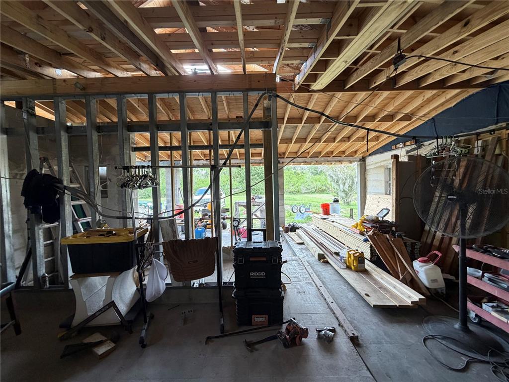 A kitchen features a white refrigerator, wood-look flooring, and a doorway leading to another room — 1315 S SHORE DRIVE, ST CLOUD, FL