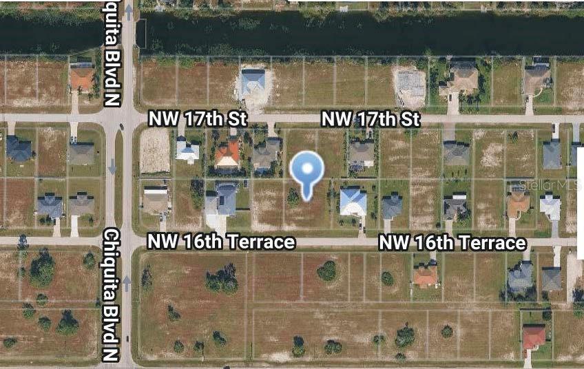 This is an aerial map showing a vacant residential lot marked with a blue pin — 1511 NW 16TH TERRACE, CAPE CORAL, FL