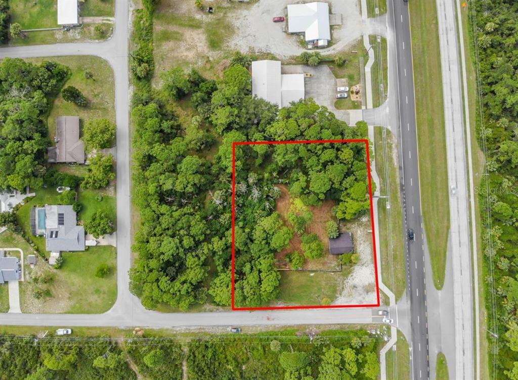 An aerial view shows a rectangular plot of land outlined in red with trees — 3609 S RIDGEWOOD AVENUE UNIT 0, EDGEWATER, FL