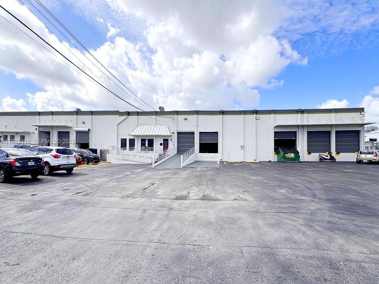 A commercial warehouse building features multiple loading docks and a paved parking lot — 1950 NW 70th Ave # 1970, Miami FL 33126, MIAMI, FL