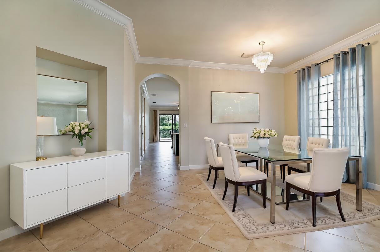 A dining room with a glass table, white chairs, a sideboard, and tile flooring — 8904 Sea Chase Drive, Lake Worth FL 33467, LAKE WORTH, FL
