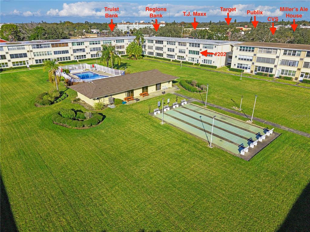 An aerial view shows a residential apartment complex with a pool and shuffleboard court — 8100 DR MARTIN LUTHER KING JR STREET N UNIT 202, ST PETERSBURG, FL