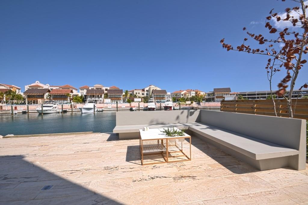 A stone patio features a built-in concrete bench and a small table overlooking a marina — 0 Marina cc, FL, FL