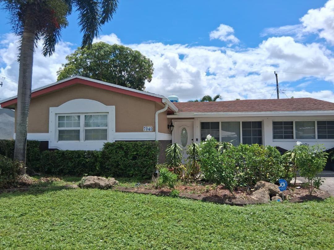A single-story house with a brown exterior, white trim, and a landscaped front yard — 7040 SW 29th Street, Miramar FL 33023, MIRAMAR, FL