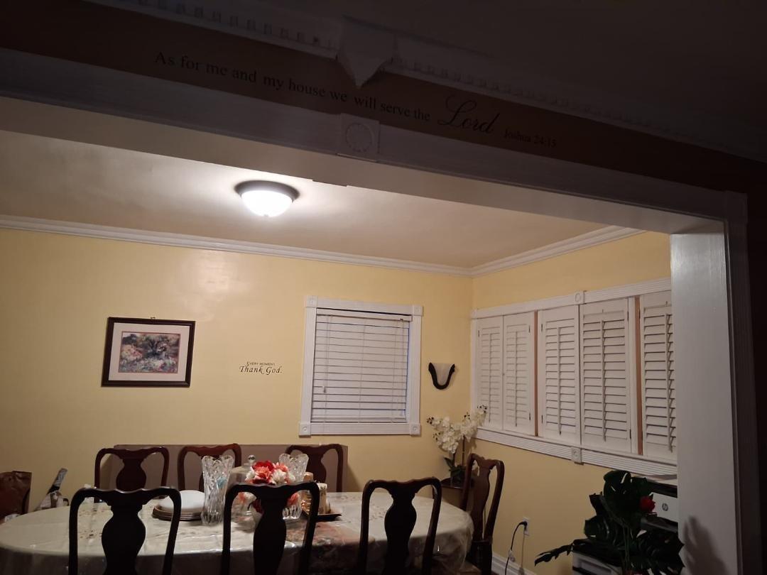 A dining room with yellow walls, a wooden table with chairs, and white plantation shutters — 7040 SW 29th Street, Miramar FL 33023, MIRAMAR, FL