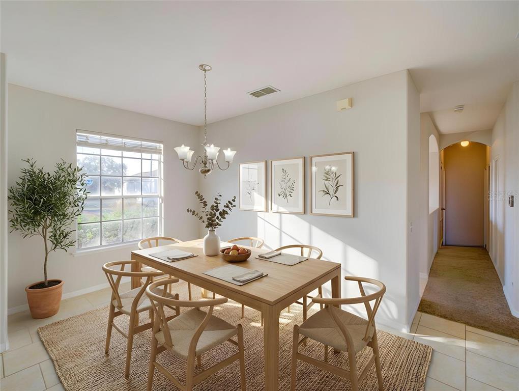 A dining room features a wooden table, four chairs, a chandelier, and three framed prints — 735 PALAISEAU CT, KISSIMMEE, FL