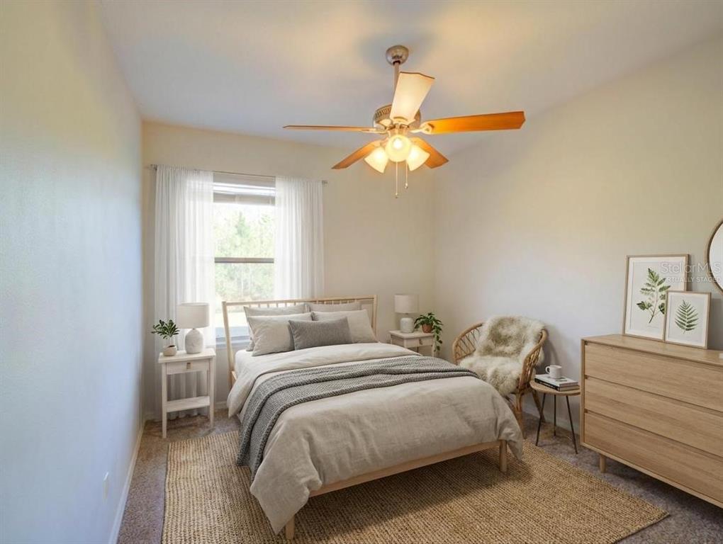 A bedroom features a bed, a ceiling fan, a dresser, and a window with curtains — 735 PALAISEAU CT, KISSIMMEE, FL