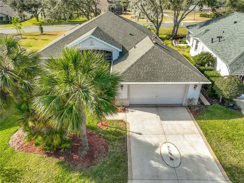 An aerial view of a single-story house with a two-car garage and palm tree — 5685 GULF STREAM STREET, TAVARES, FL