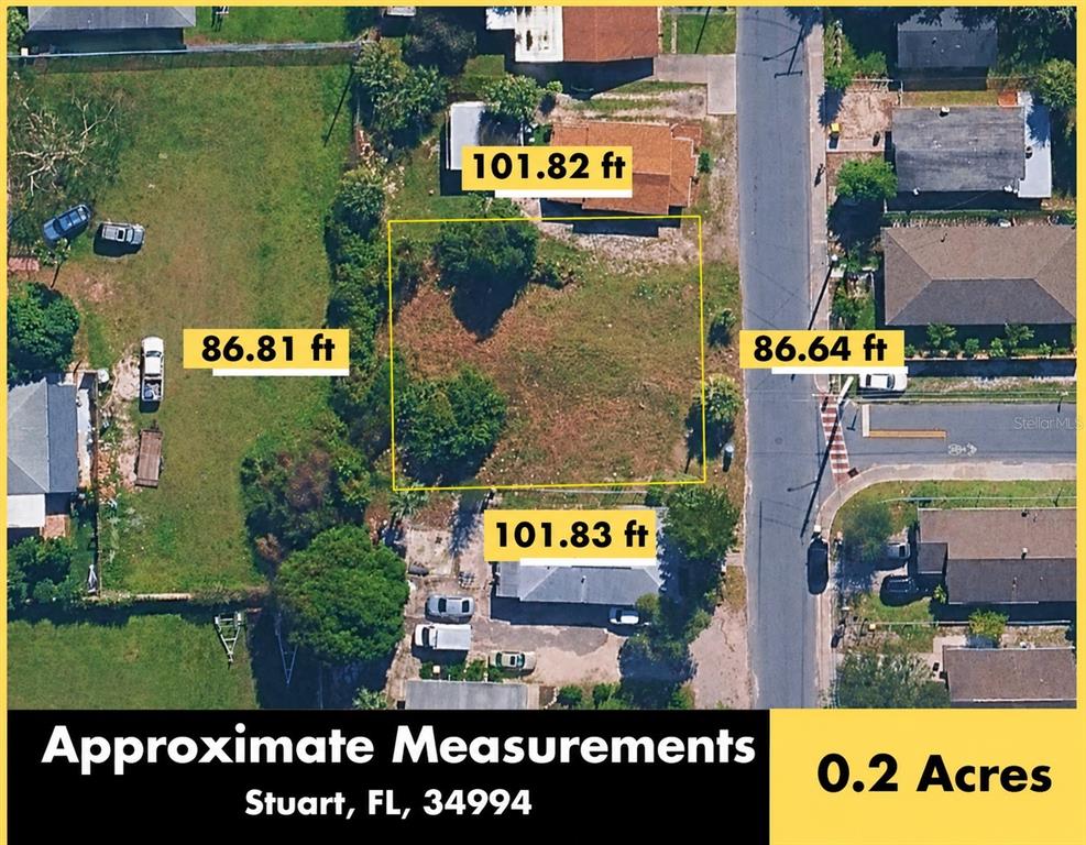 An aerial view of a rectangular vacant lot with property dimensions overlaid on the image — 833 SE TARPON AVENUE, STUART, FL