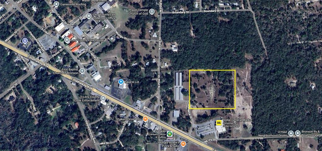 This is an aerial map view showing a vacant rectangular lot outlined in yellow — TBD COMMERCE STREET, BRONSON, FL